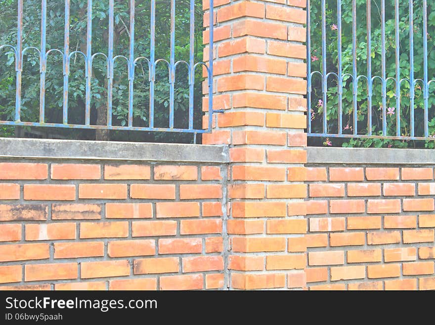 Old Brick Wall and Iron Fence on Top of it