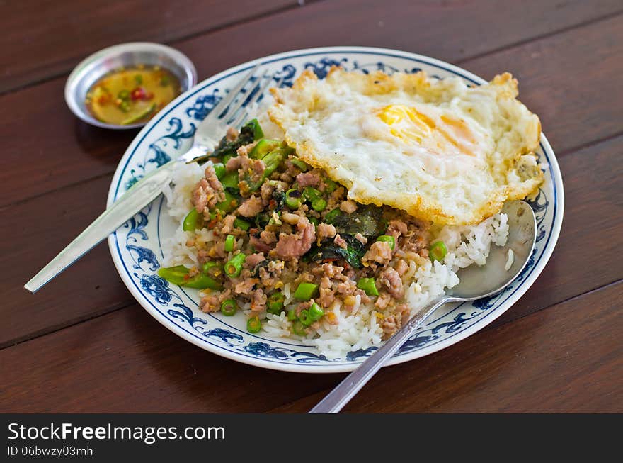 Stir fried pork with basil and egg on rice,Thai popular menu