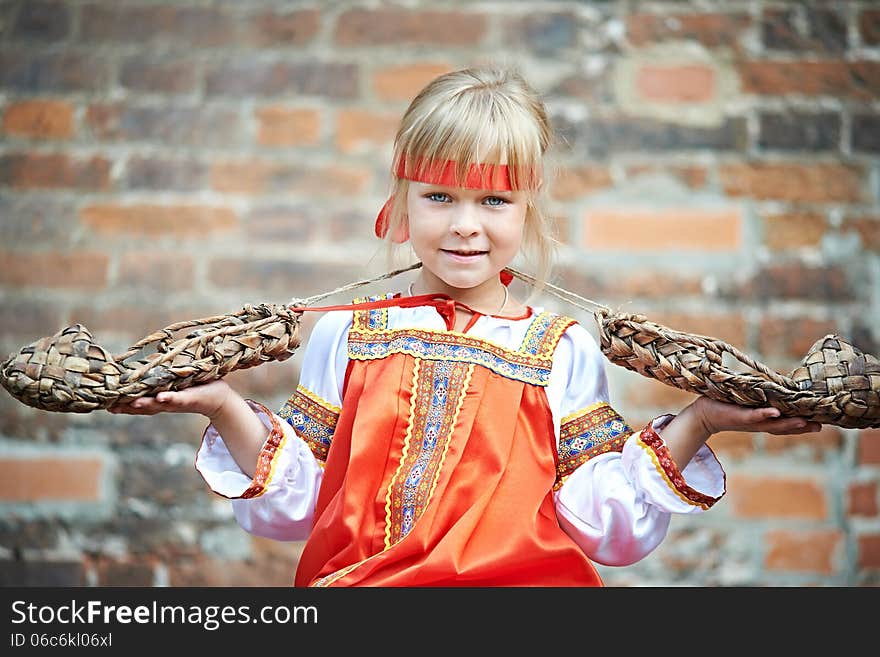 Little Girl In National Costumes With Bast