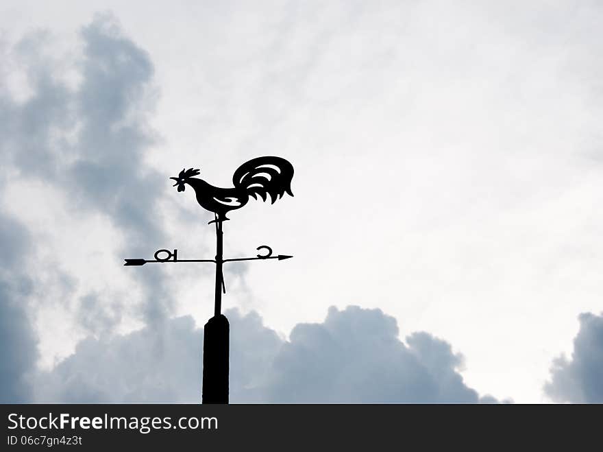 Weather vane against the evening sky and clouds. Weather vane against the evening sky and clouds