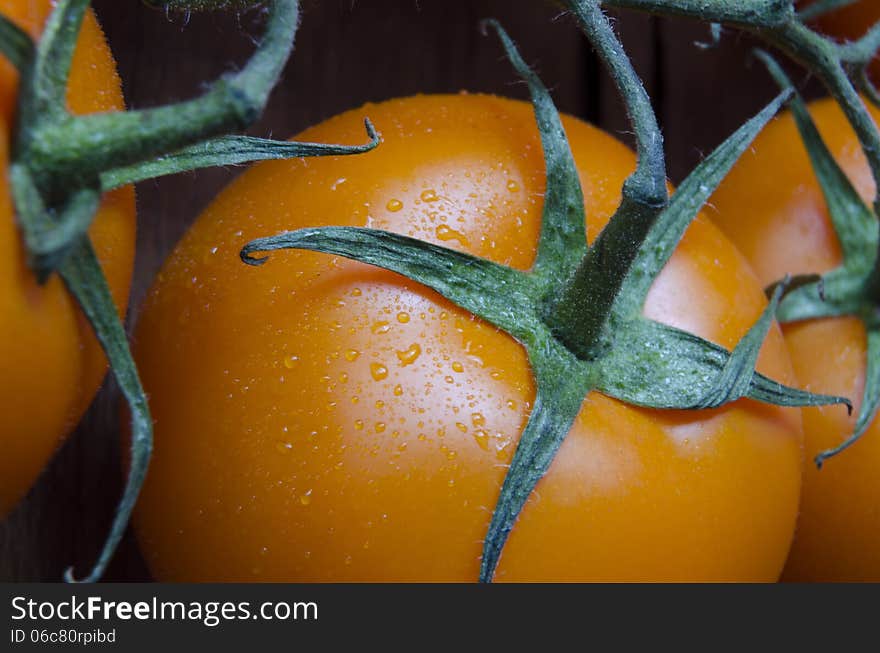 Fresh juicy orange tomatoes closeup