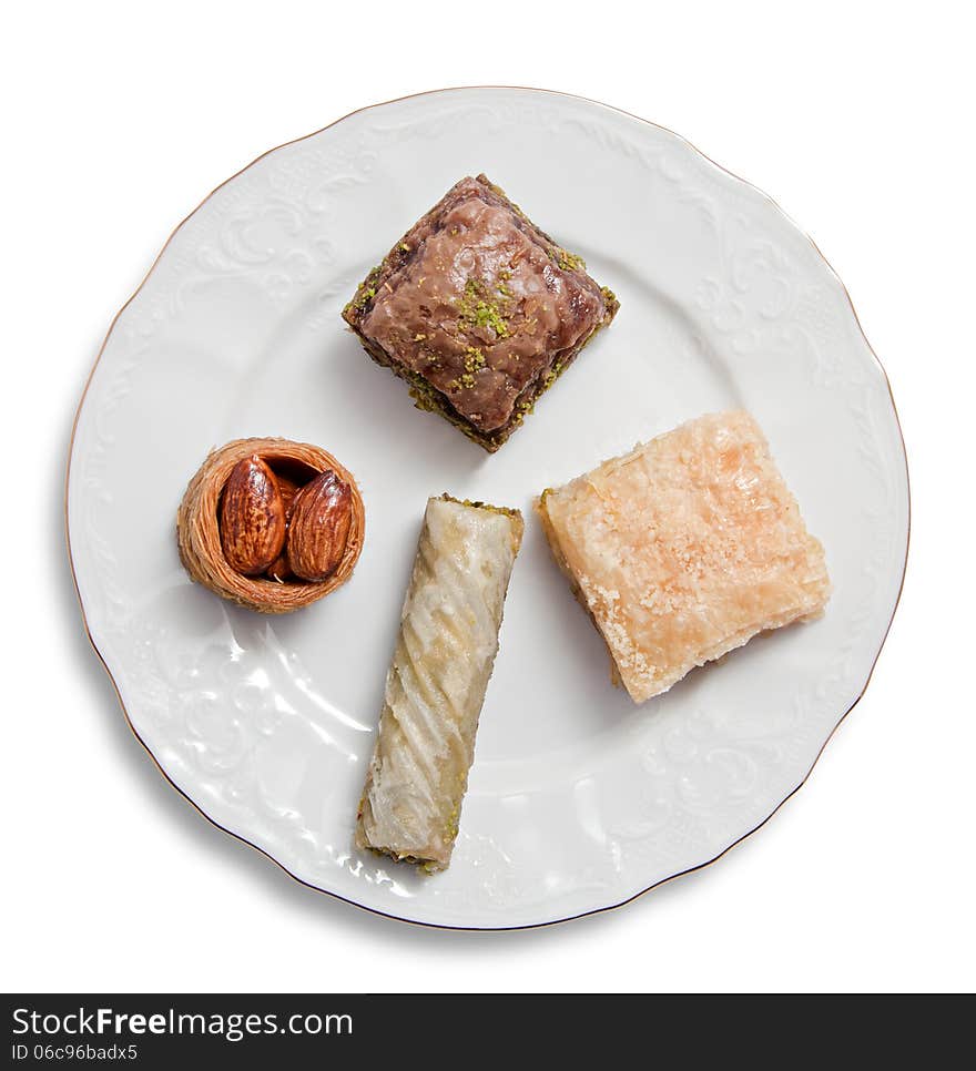 Plate with various turkish baklava isolated over white background