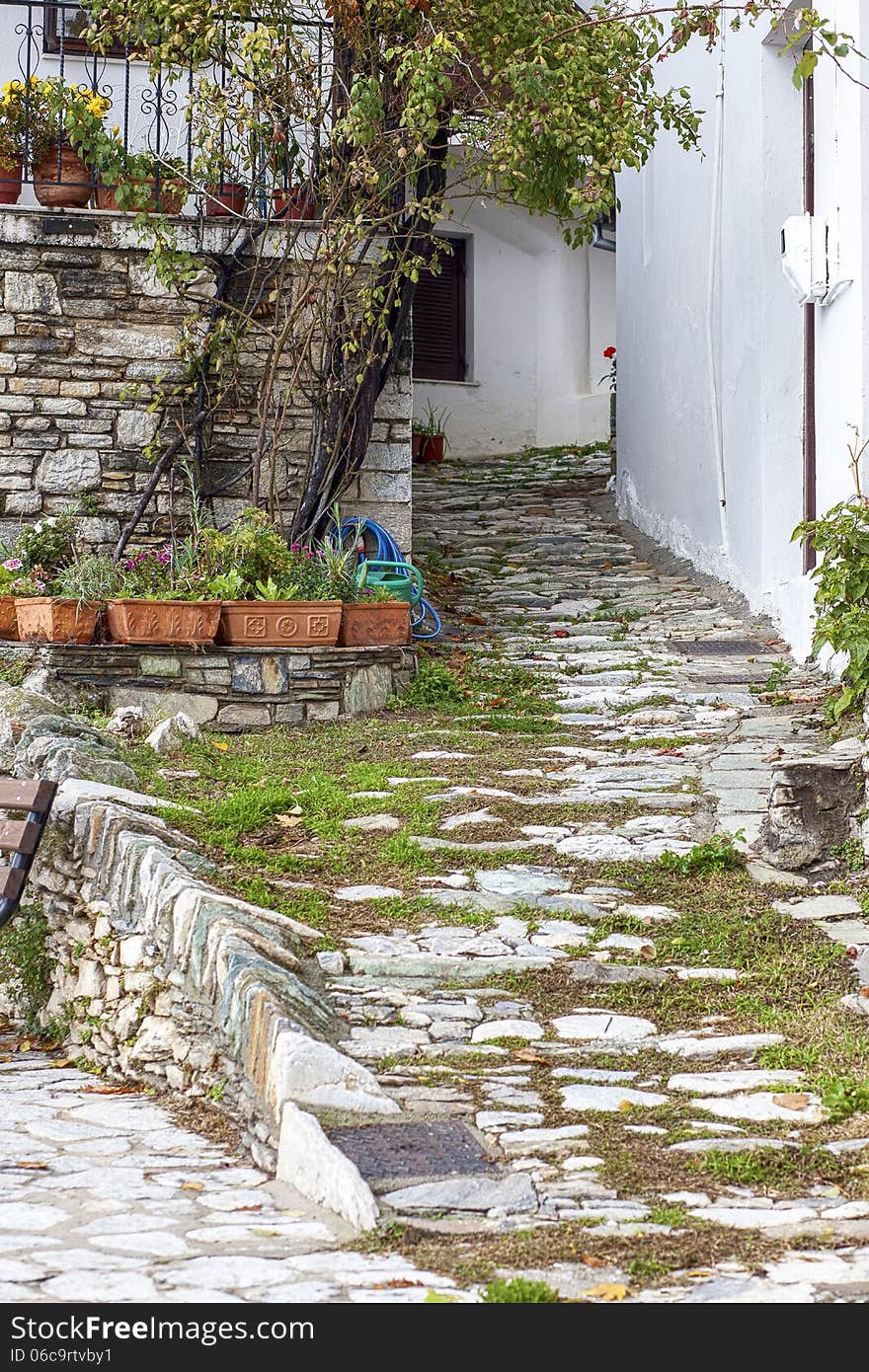 A little alley with rocks and plants in Makrinitsa village, Pelion, Greece. A little alley with rocks and plants in Makrinitsa village, Pelion, Greece