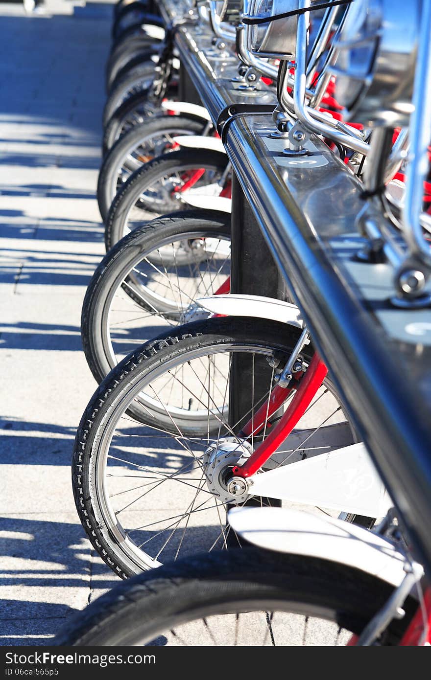 Few bicycles for rent in a row on street parking. Few bicycles for rent in a row on street parking