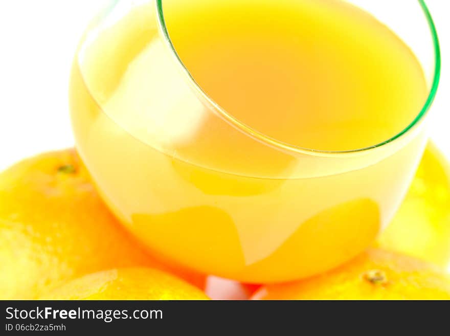 Clementines with juice in glass on isolated background. Clementines with juice in glass on isolated background