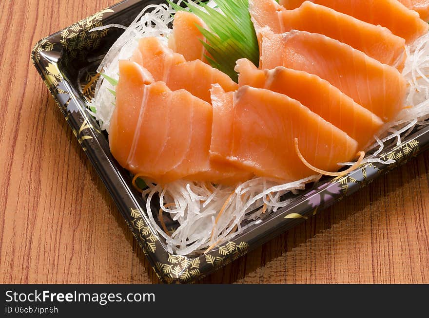 Fresh salmon piece for sushi on wood background. Fresh salmon piece for sushi on wood background