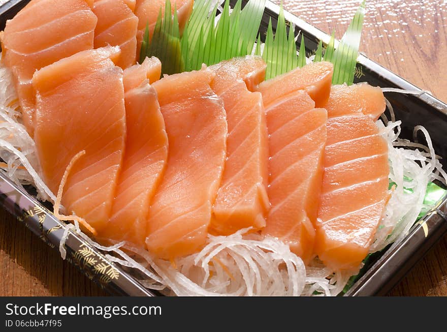 Fresh salmon piece for sushi on wood background. Fresh salmon piece for sushi on wood background