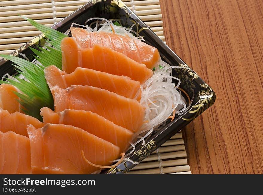 Fresh salmon piece for sushi on wood background. Fresh salmon piece for sushi on wood background