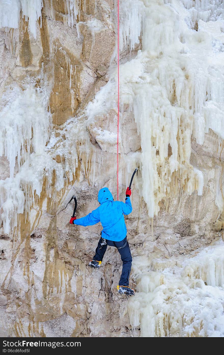 Young man climbing the ice