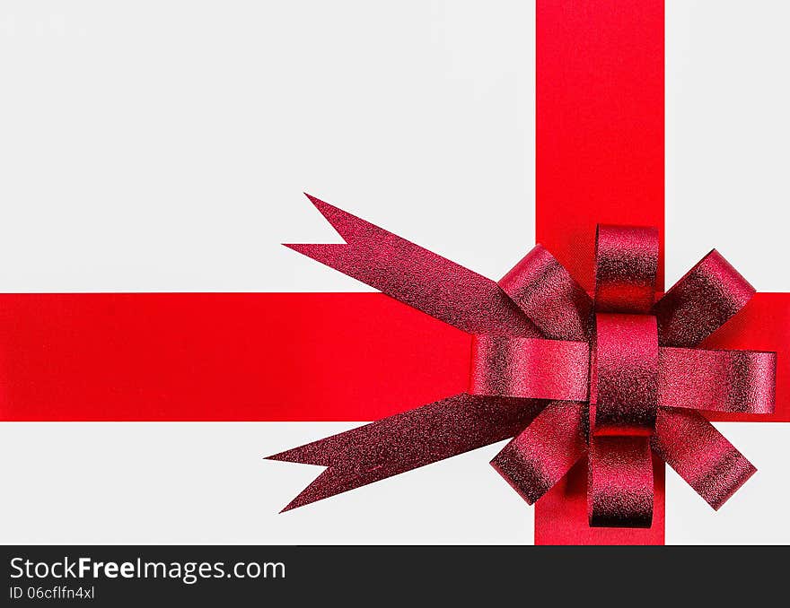 Ribbon and red bow on white background