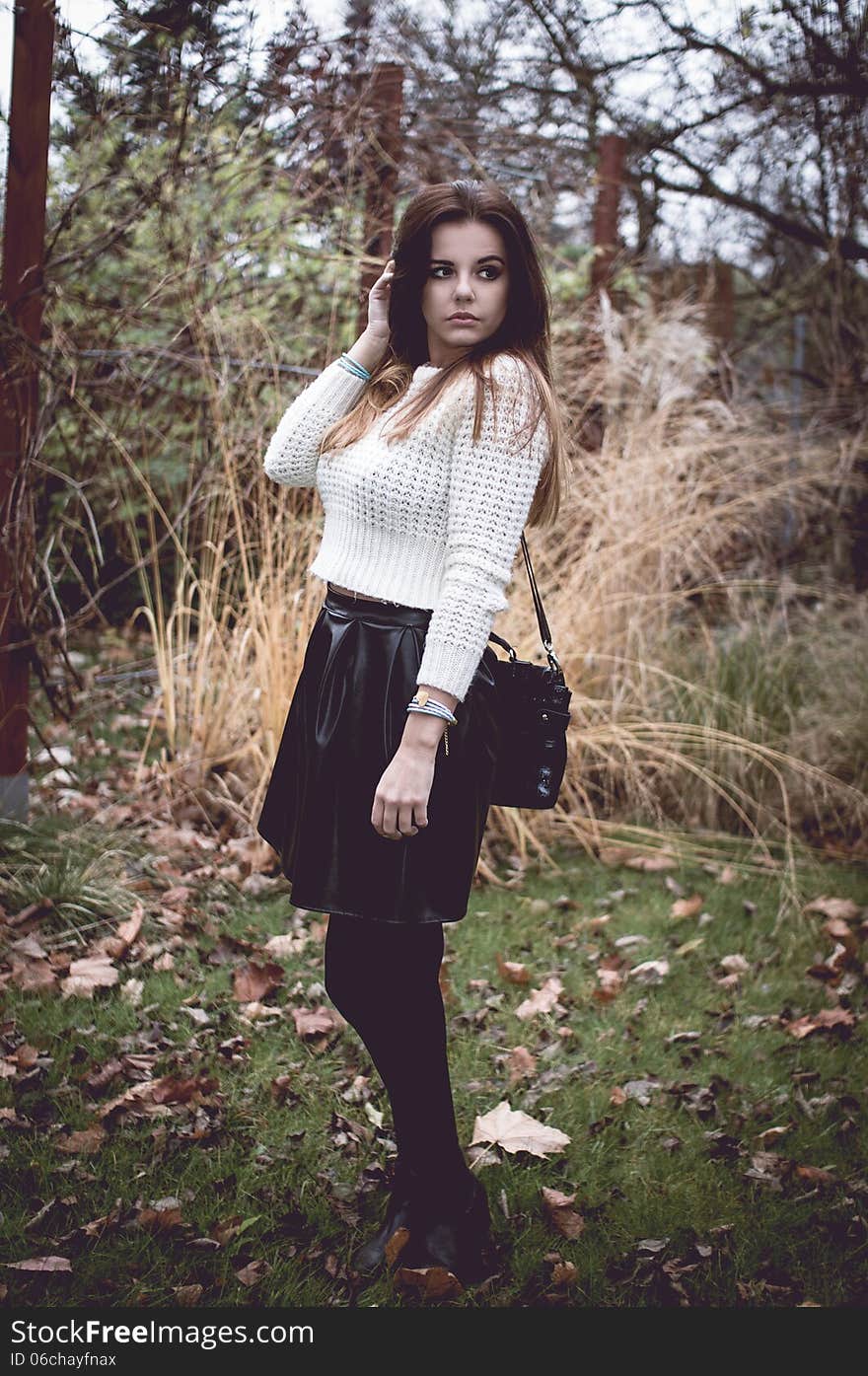 Young woman with silver jewelary on hand in white sweater. Young woman with silver jewelary on hand in white sweater