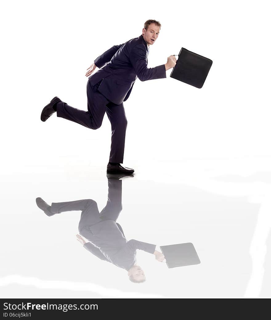 A businessman running with a briefcase on a white background. A businessman running with a briefcase on a white background.