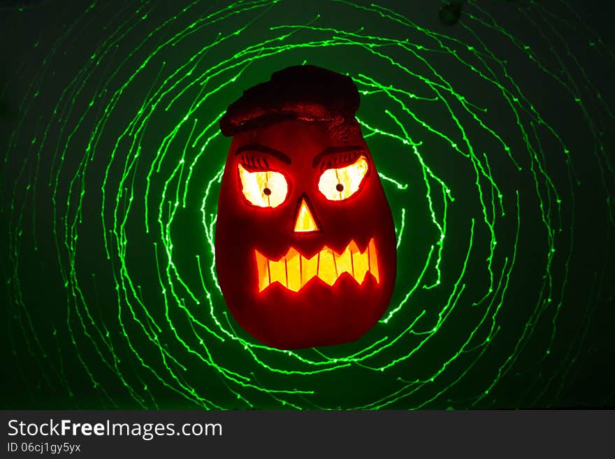 Pumpkin lit for halloween a laser light backgraund. Pumpkin lit for halloween a laser light backgraund