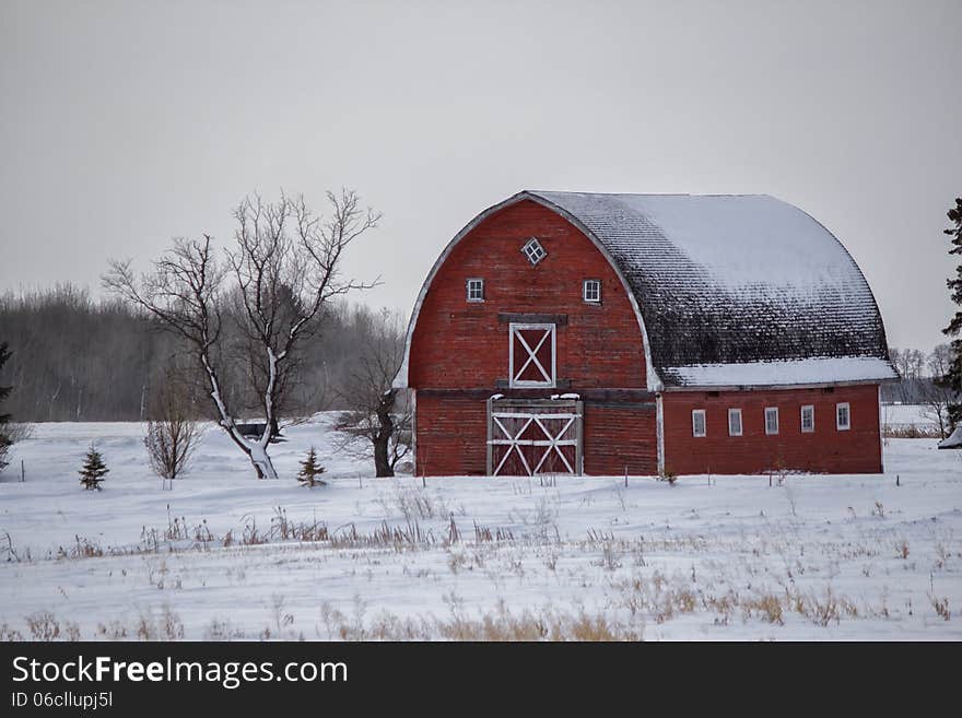 Old red barn surrounded by snow. Old red barn surrounded by snow