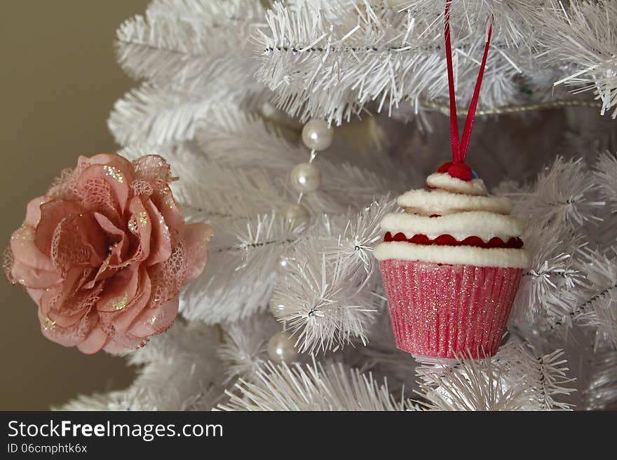 Christmas white tree, with a flower and cupcake. Christmas white tree, with a flower and cupcake