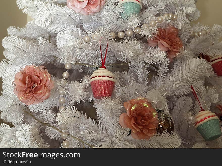 Christmas white tree, with a flower and cupcake. Christmas white tree, with a flower and cupcake