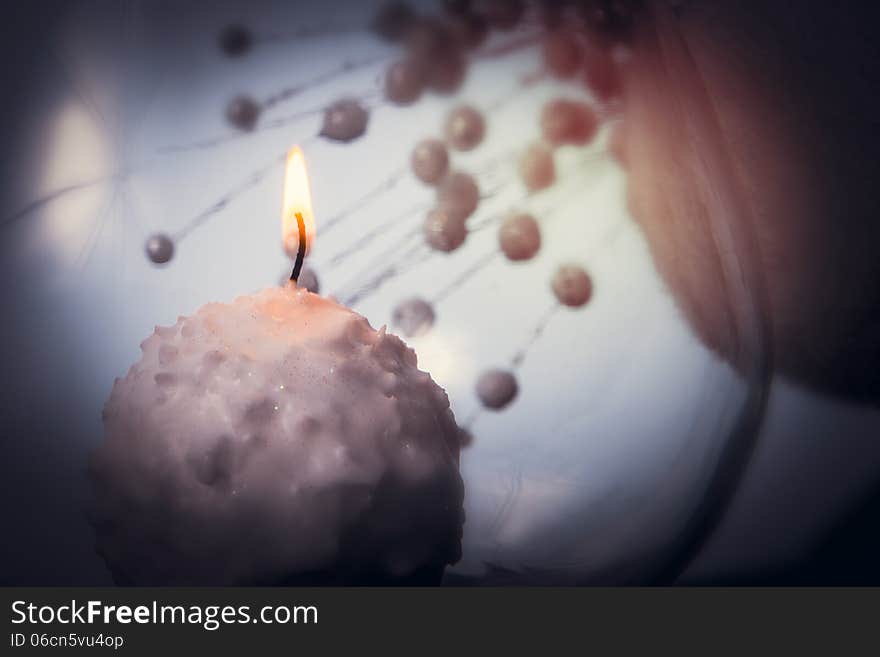 Small candle burning and melting like a snowball over abstract background. Small candle burning and melting like a snowball over abstract background.