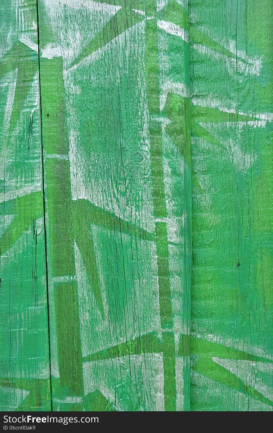 Painted green bamboo on a wooden fence. Painted green bamboo on a wooden fence.