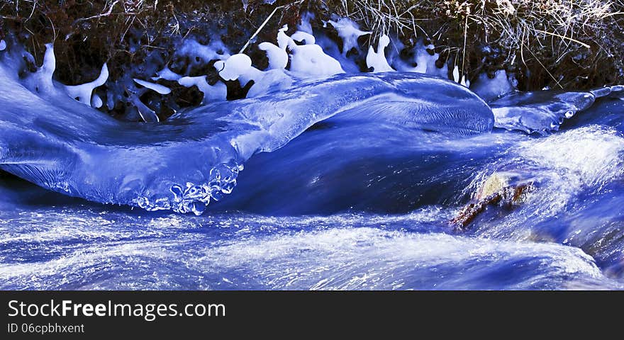 Ice shroud sculpted by the fast flowing water of an Icelandic Stream. Ice shroud sculpted by the fast flowing water of an Icelandic Stream