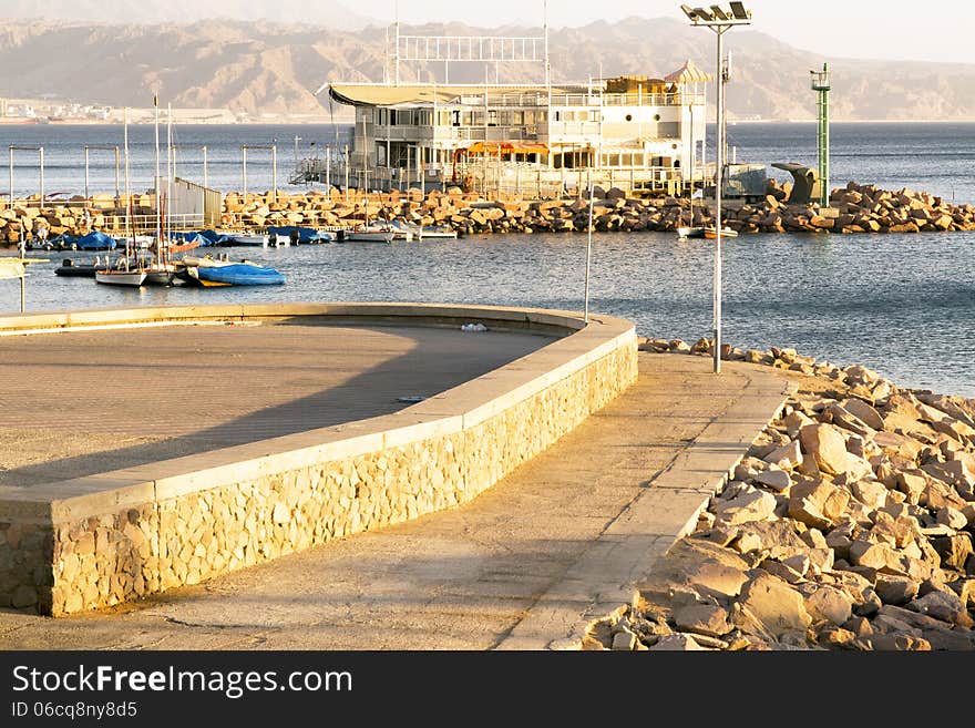 Popular Israeli resort Eilat. Quay. Sunset. View of the Jordanian city Aqaba