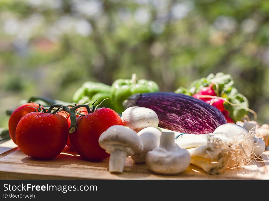 Fresh vegetables on wooden chopping board