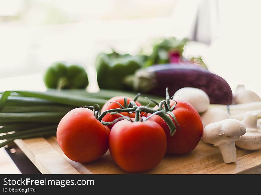 Homegrown organic produce on wooden cutting board outdoors. Homegrown organic produce on wooden cutting board outdoors