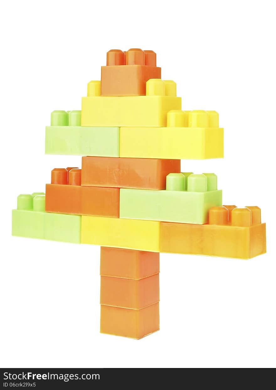 Color brick toy assembly in christmas tree shape on white background. Color brick toy assembly in christmas tree shape on white background