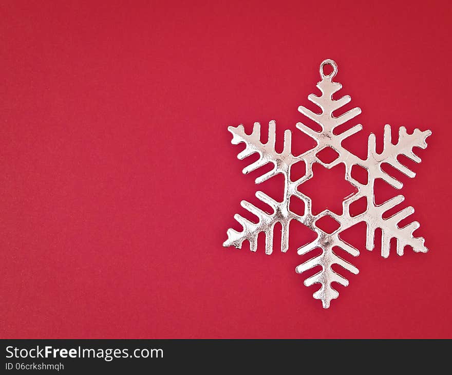 Sliver snowflake on red