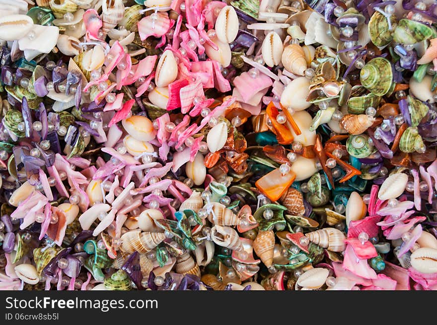 Pile of jewelery made of precious stones and sea shels. Pile of jewelery made of precious stones and sea shels