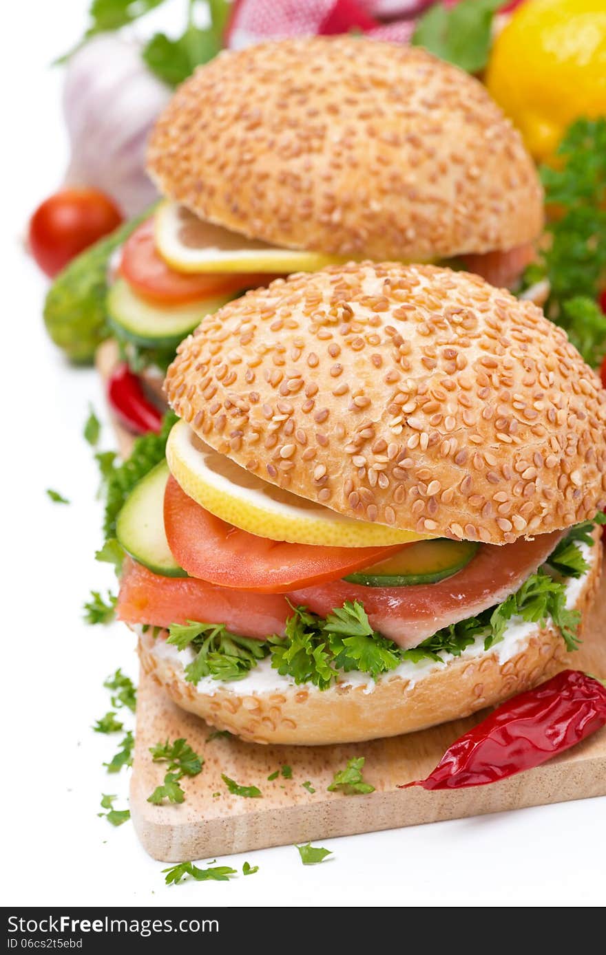 Burger with smoked salmon and vegetables, isolated on white