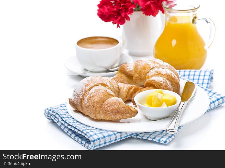 Croissants with butter, cup of coffee and juice for breakfast