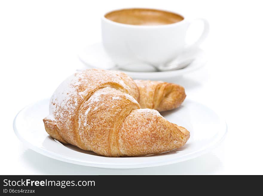 Delicious croissant and cup of black coffee, close-up