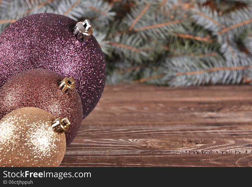 Christmas Balls And Pine Needles On Wooden Background