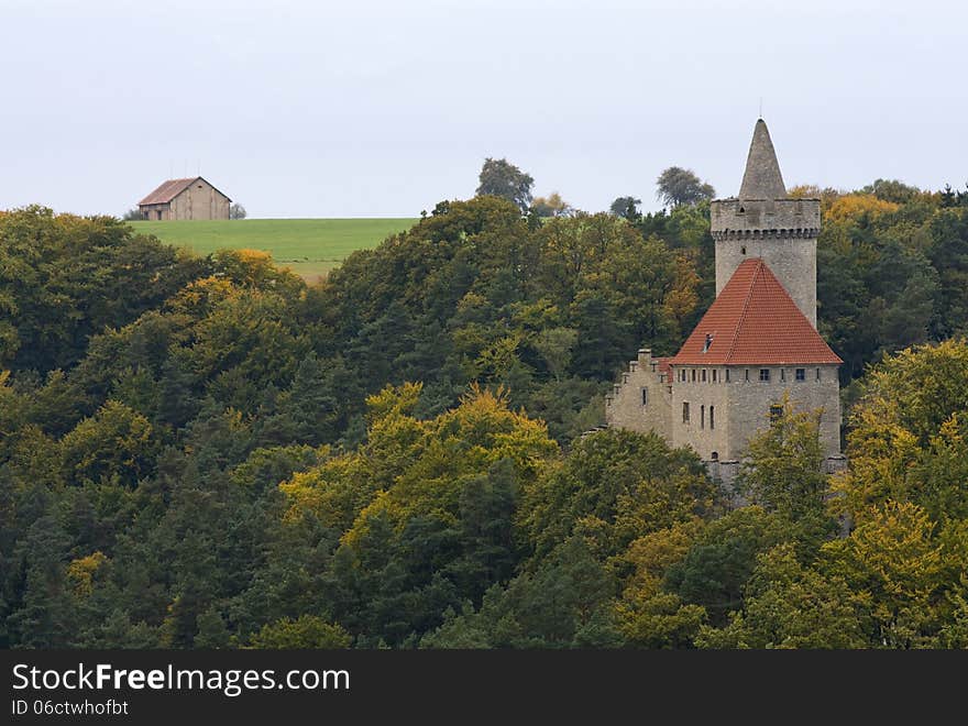 Castle in autumn forest and barn in the background on a meadow. Castle in autumn forest and barn in the background on a meadow