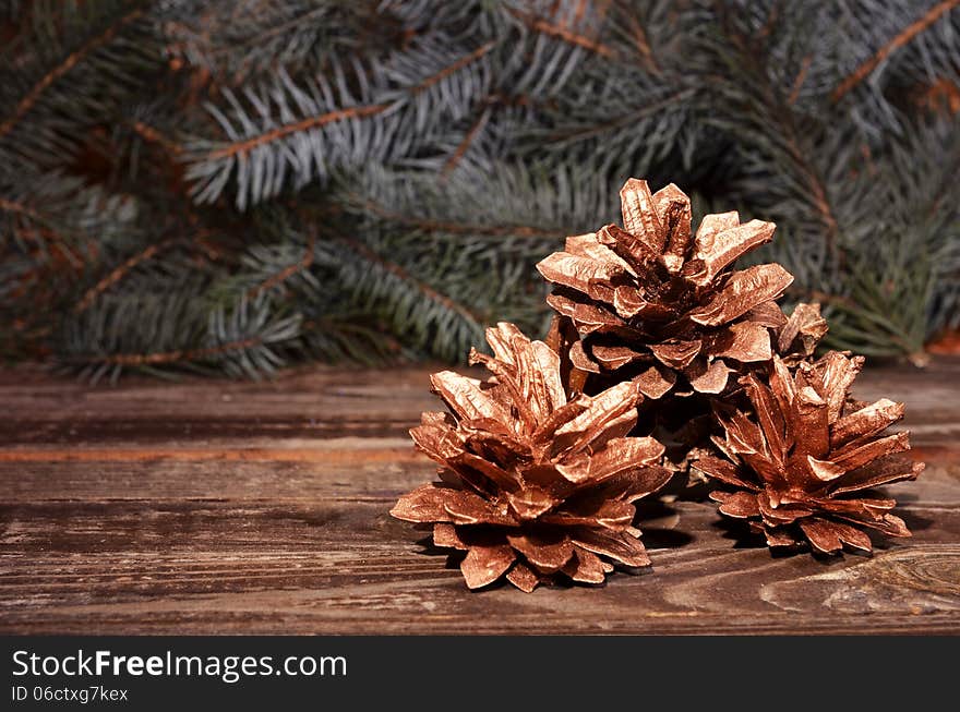 New Year`s composition of a pine cones on a wooden background