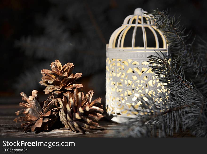 New Year`s composition of a pine cones and Vintage Christmas candlestick on a wooden background
