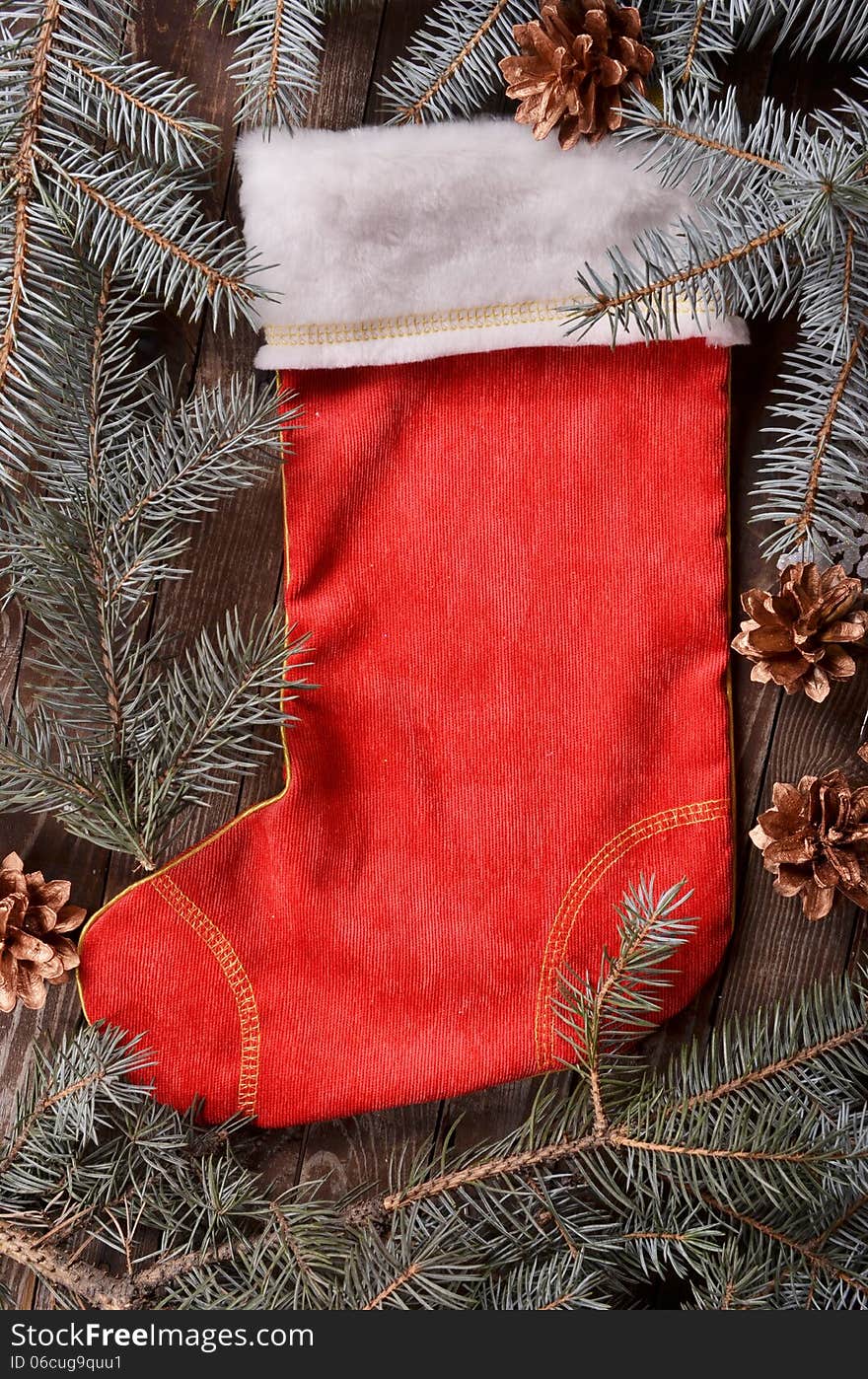 New Year`s composition of a red Christmas sock and fir branches