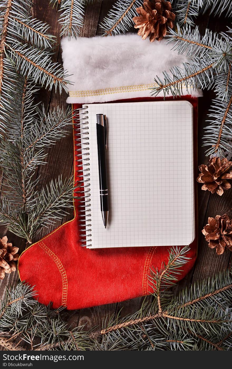 New Year`s composition of a red Christmas sock and fir branches