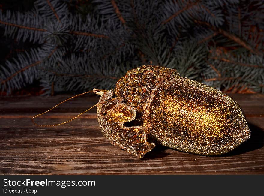 Christmas golden acorn and spruce twigs on a wooden background