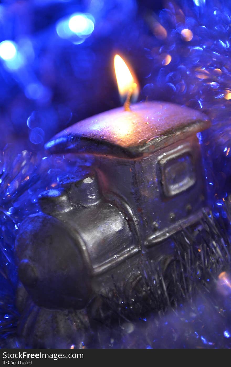 New Year`s composition of a candle and tinsel