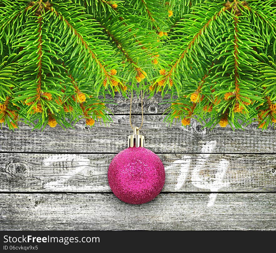 Branches of  Christmas tree on a  wooden background.