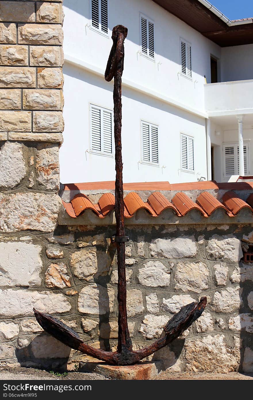 Old rusty anchor in front of a new house in Razanac, Dalmatia, Croatia. Old rusty anchor in front of a new house in Razanac, Dalmatia, Croatia