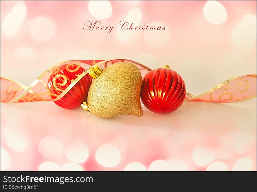 Merry Christmas card, with christmas decorations, ribbon, soft background lights and text. Room for more text.