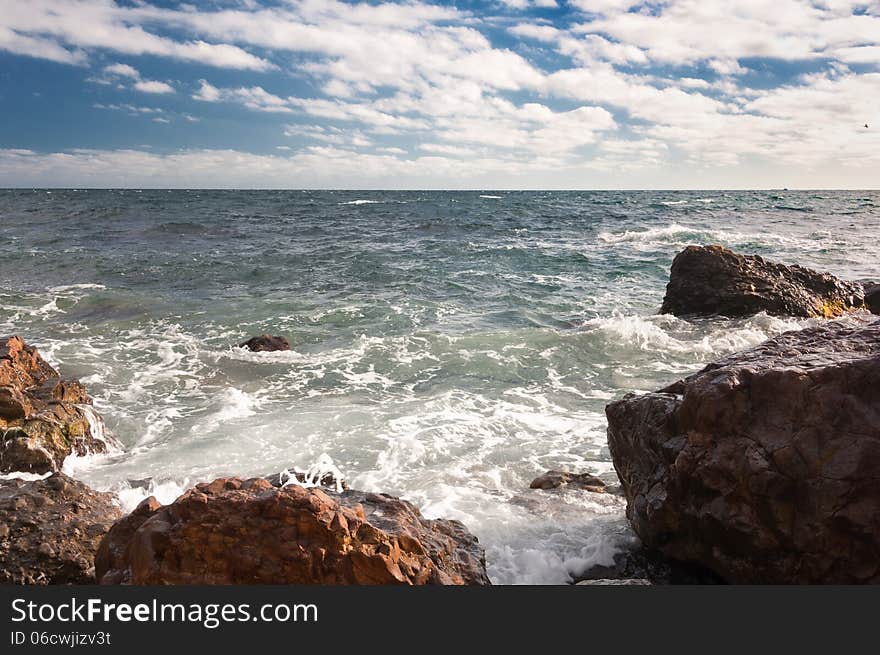 Ukraine, peninsula of Crimea, Sea coast on the Black Sea, large and small pebbles, large boulders, sea waves. Ukraine, peninsula of Crimea, Sea coast on the Black Sea, large and small pebbles, large boulders, sea waves