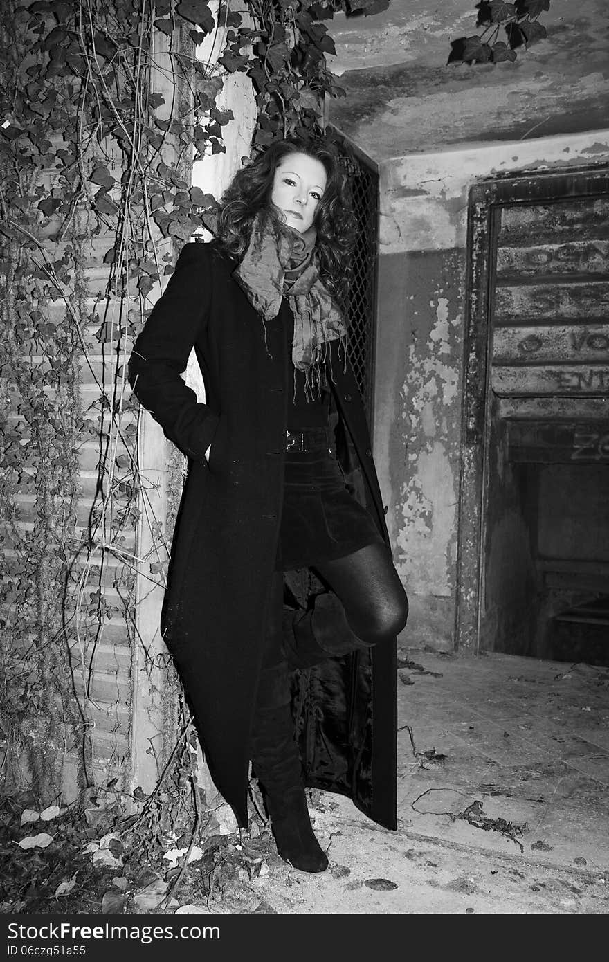 Model posing in long coat in abandoned place. Model posing in long coat in abandoned place