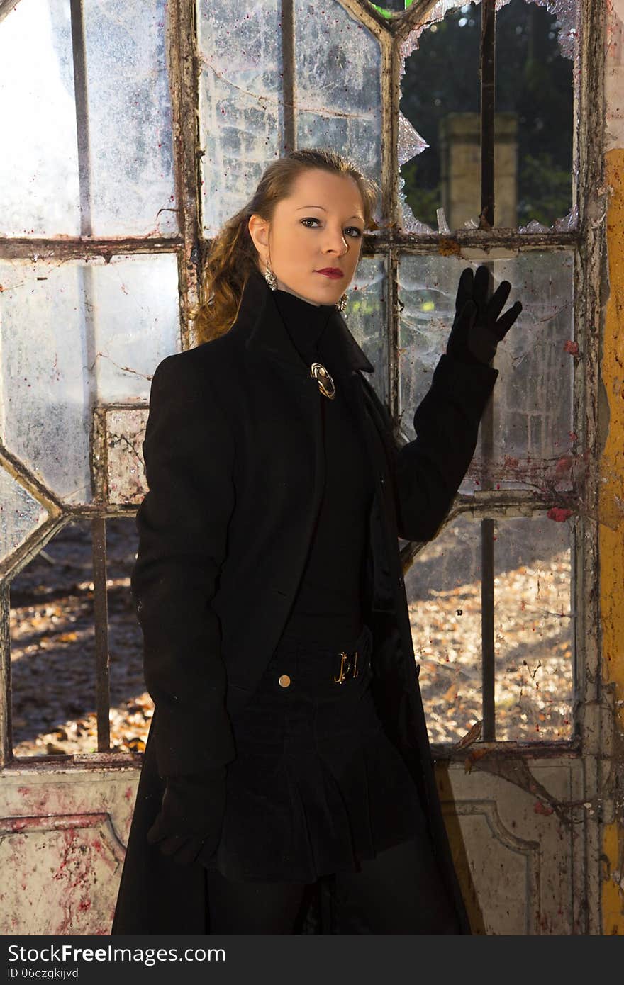 Model posing in long coat in abandoned place. Model posing in long coat in abandoned place