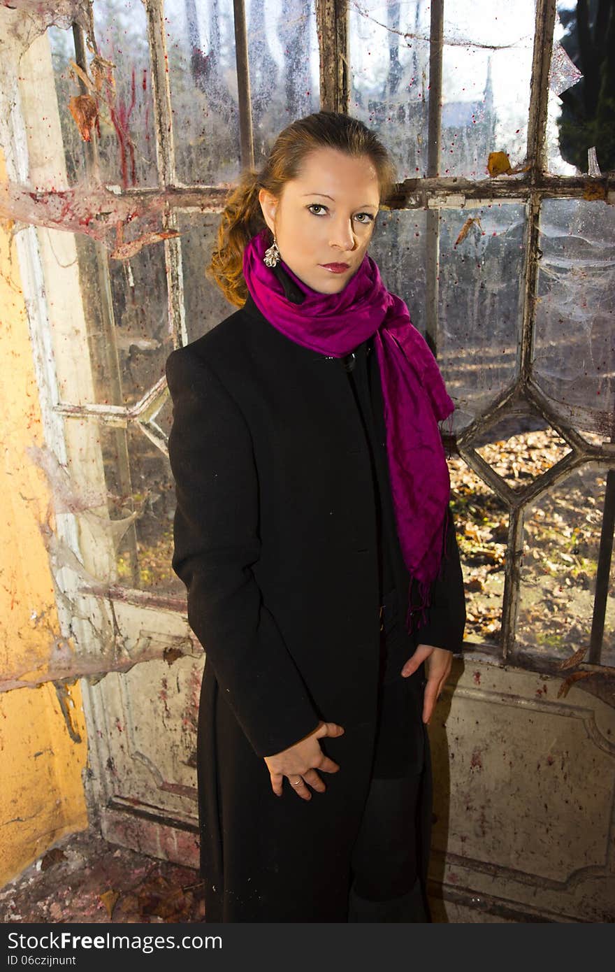 Model posing in long coat in abandoned place. Model posing in long coat in abandoned place