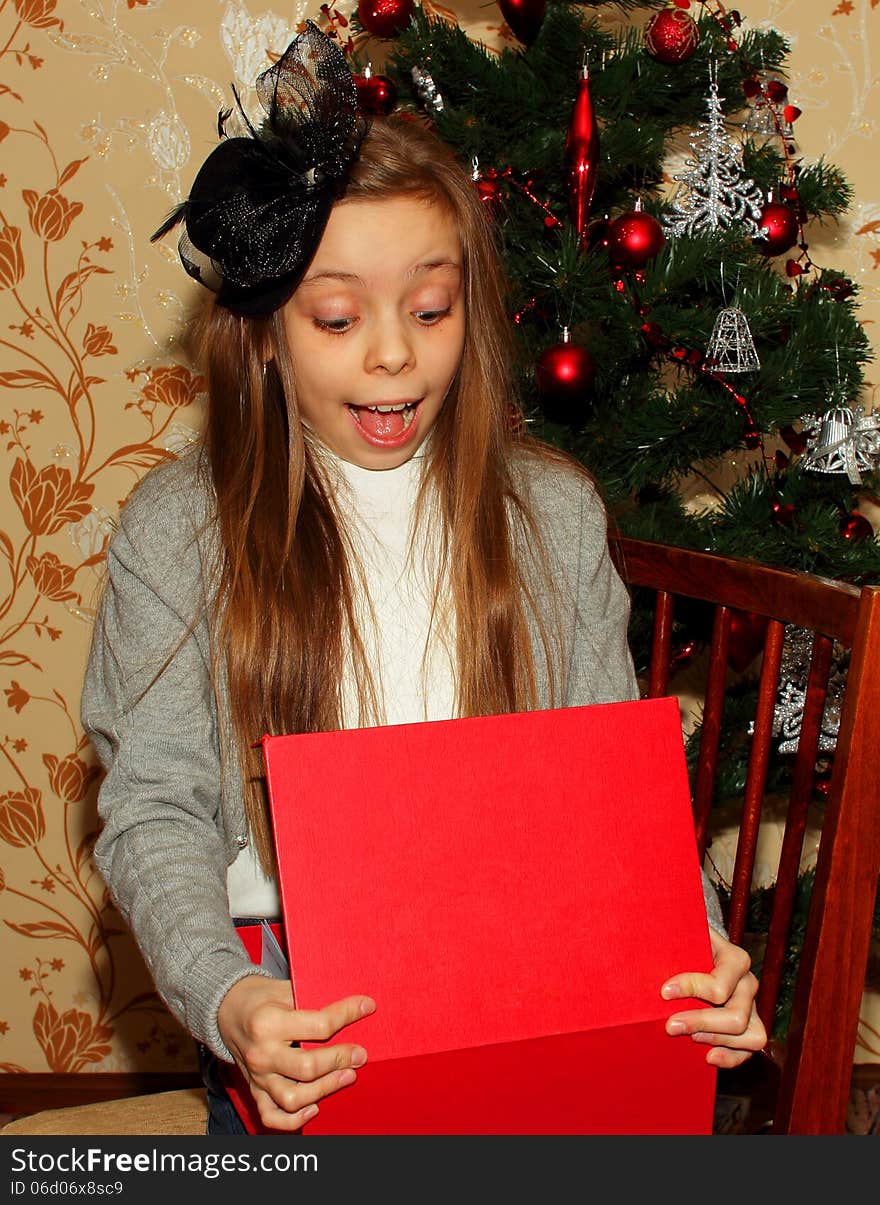 Pretty Little Girl In A Hat Surprised By Receiving Gifts