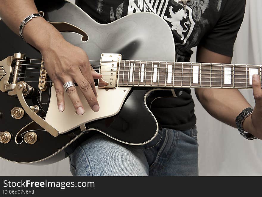 Male strumming on a guitar. Male strumming on a guitar