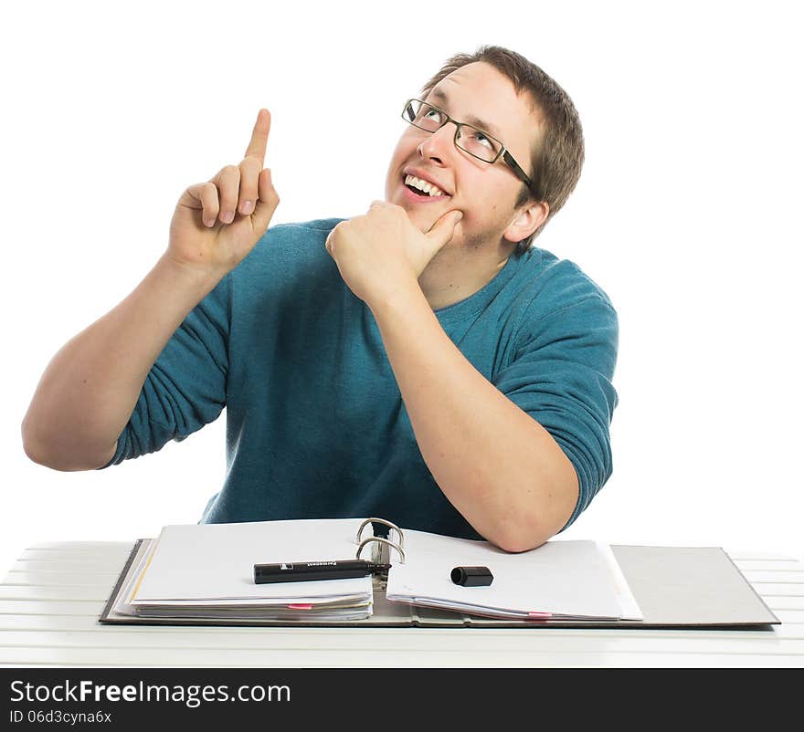 One man sitting at a desk thinking and pointing up